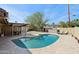 Beautiful pool surrounded by a stone patio with a covered area for outdoor dining at 3830 E Desert Cove Ave, Phoenix, AZ 85028