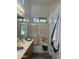 Bright bathroom featuring a shower-tub combo with glass doors, vanity sink, and modern fixtures at 4031 E Barwick Dr, Cave Creek, AZ 85331