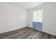This bedroom has wood-look flooring and a bright window with curtains at 4031 E Barwick Dr, Cave Creek, AZ 85331