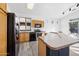 Kitchen featuring a breakfast bar, light wood cabinets, and black appliances at 4031 E Barwick Dr, Cave Creek, AZ 85331