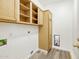 Bright laundry room with wooden cabinets, shelving, and tile floors at 4031 E Barwick Dr, Cave Creek, AZ 85331