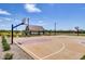 Community basketball court with covered seating, landscaping, and residential homes in the background at 4196 E Kolin Ln, San Tan Valley, AZ 85143