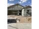 Unfinished exterior elevation featuring scaffolding and dirt lot in front of a gray stucco house with garage at 4196 E Kolin Ln, San Tan Valley, AZ 85143