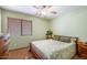 Cozy bedroom features a ceiling fan, a window with wood blinds, and neutral wall colors at 43261 W Neely Dr, Maricopa, AZ 85138