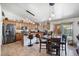 Spacious kitchen with stainless steel appliances, granite counters, island, and breakfast table with access to pool at 43261 W Neely Dr, Maricopa, AZ 85138