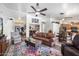 Spacious living room with comfortable seating, a ceiling fan, and an open layout leading to other living spaces at 43261 W Neely Dr, Maricopa, AZ 85138
