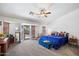Bright main bedroom with French doors to private patio, fan, and lots of natural light at 43261 W Neely Dr, Maricopa, AZ 85138