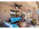 Covered patio with comfortable seating, a ceiling fan, and a stylish outdoor fire pit at 43261 W Neely Dr, Maricopa, AZ 85138