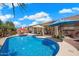 Stunning backyard with sparkling pool, covered patio, and lush landscaping perfect for outdoor entertaining at 43261 W Neely Dr, Maricopa, AZ 85138