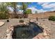 Landscaped backyard featuring a decorative water fountain at 450 E Duke Dr, Casa Grande, AZ 85122