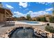 Landscaped backyard featuring a pool, patio, and decorative fountain at 450 E Duke Dr, Casa Grande, AZ 85122