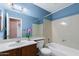 Functional bathroom featuring a shower-tub combo, a sink with counter, and a neutral color scheme at 450 E Duke Dr, Casa Grande, AZ 85122