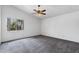 Bright bedroom featuring neutral carpet, a ceiling fan, a large window, and ample natural light at 450 E Duke Dr, Casa Grande, AZ 85122