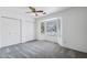 Bright bedroom featuring a ceiling fan, large window, and spacious closet at 450 E Duke Dr, Casa Grande, AZ 85122