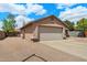 Traditional home featuring an attached two-car garage and desert landscaping at 450 E Duke Dr, Casa Grande, AZ 85122