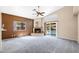 Spacious living room features vaulted ceiling, fireplace, plush carpet, and sliding glass doors to the pool at 450 E Duke Dr, Casa Grande, AZ 85122