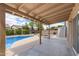 Covered patio overlooking the pool and landscaped backyard at 450 E Duke Dr, Casa Grande, AZ 85122