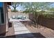 Relaxing backyard with comfortable seating, paver stones, desert landscaping, and mature trees for shade at 5013 E Shomi St, Phoenix, AZ 85044