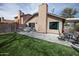 Spacious backyard with a brick paver patio, artificial turf, and comfortable outdoor seating at 5013 E Shomi St, Phoenix, AZ 85044