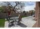 Inviting backyard patio featuring a paver patio, artificial turf, and an outdoor dining set for entertaining at 5013 E Shomi St, Phoenix, AZ 85044
