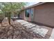 Charming backyard showcasing a stone paver path leading to a covered patio and lush landscaping at 5013 E Shomi St, Phoenix, AZ 85044