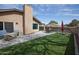 Inviting backyard featuring artificial turf, a brick paver patio, and an outdoor dining set at 5013 E Shomi St, Phoenix, AZ 85044