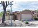 Charming single-story home with a two-car garage, desert landscaping, and a welcoming facade at 5013 E Shomi St, Phoenix, AZ 85044
