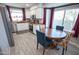 Well-lit kitchen with stainless steel appliances, white cabinets, and an eat-in dining area at 5013 E Shomi St, Phoenix, AZ 85044