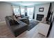 Cozy living room with a comfortable sectional sofa, fireplace, and lots of natural light at 5013 E Shomi St, Phoenix, AZ 85044