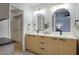 Bathroom features a dual sink vanity, modern lighting, and a walk-in closet at 614 W Kings Ave, Phoenix, AZ 85023
