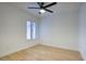 Bedroom with hardwood floors, ceiling fan, and natural light from window at 614 W Kings Ave, Phoenix, AZ 85023