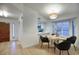 Cozy dining area with stylish lighting and views of the kitchen with window shutters allowing natural light at 614 W Kings Ave, Phoenix, AZ 85023