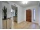 Inviting foyer with wood-look flooring, coat closet, stylish entry door, and convenient pass-through to the kitchen at 614 W Kings Ave, Phoenix, AZ 85023