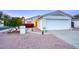 Charming single-story home with two-car garage, xeriscape landscape, and inviting entryway with mature landscaping at 614 W Kings Ave, Phoenix, AZ 85023