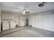 Spacious garage with white cabinets, washer, dryer, and a ceiling fan for added convenience at 614 W Kings Ave, Phoenix, AZ 85023