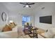 Bright living room with ceiling fan, modern decor, plush seating, and access to the outdoor sun room at 614 W Kings Ave, Phoenix, AZ 85023