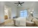 Light and airy primary bedroom features private bath access, ceiling fan, and slider to the patio at 614 W Kings Ave, Phoenix, AZ 85023
