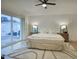 Bright primary bedroom boasts slider to private patio, ceiling fan, and neutral decor at 614 W Kings Ave, Phoenix, AZ 85023