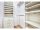 Walk-in closet features ample shelving, storage drawers, and hanging racks for organizing clothes at 614 W Kings Ave, Phoenix, AZ 85023