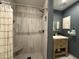 Modern bathroom features a tiled shower with a built-in seat and a stylish vanity with storage at 6207 W Orange Dr, Glendale, AZ 85301