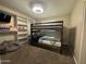 Bedroom featuring a charming bunk bed and a built-in closet with ample shelving at 6207 W Orange Dr, Glendale, AZ 85301
