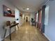 Bright hallway with neutral tile flooring, stylish decor, and plenty of natural light at 6207 W Orange Dr, Glendale, AZ 85301