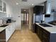 Modern kitchen with stainless steel appliances, black and white cabinetry, and bright countertops at 6207 W Orange Dr, Glendale, AZ 85301