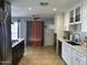 Well-appointed kitchen featuring white cabinets, stainless steel appliances, and tile floors at 6207 W Orange Dr, Glendale, AZ 85301