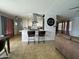 Open-concept kitchen featuring an island with seating and stainless steel appliances at 6207 W Orange Dr, Glendale, AZ 85301