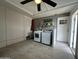 Well-lit laundry room with modern appliances, tiled floor, and additional space for storage or organization at 6207 W Orange Dr, Glendale, AZ 85301