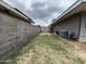 Narrow side yard with a concrete block fence, providing a private and functional outdoor space at 6207 W Orange Dr, Glendale, AZ 85301