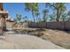 Expansive backyard featuring a paved patio, desert landscaping, and block fence under a bright blue sky at 7915 N 53Rd Dr, Glendale, AZ 85301