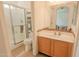 Well-maintained bathroom featuring a glass enclosed shower, tile floors, and a vanity with storage at 7915 N 53Rd Dr, Glendale, AZ 85301