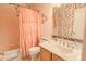 Charming bathroom featuring a floral accent wall, vanity with storage, and a shower/tub combination at 7915 N 53Rd Dr, Glendale, AZ 85301